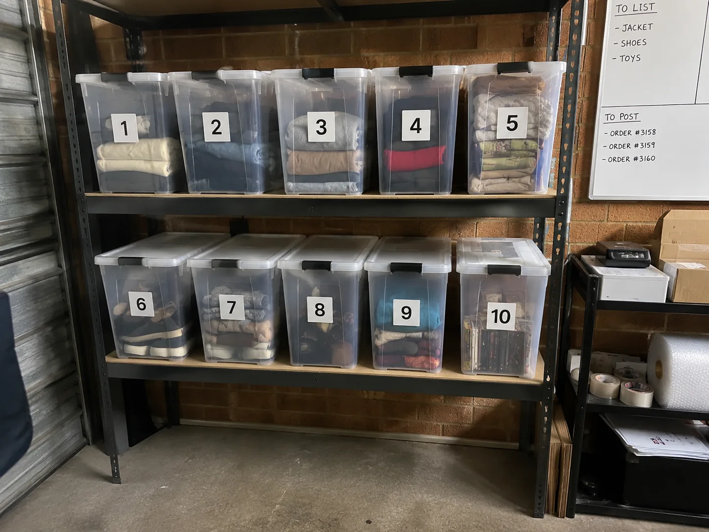 A real reseller storage setup with clear numbered tubs on shelves.